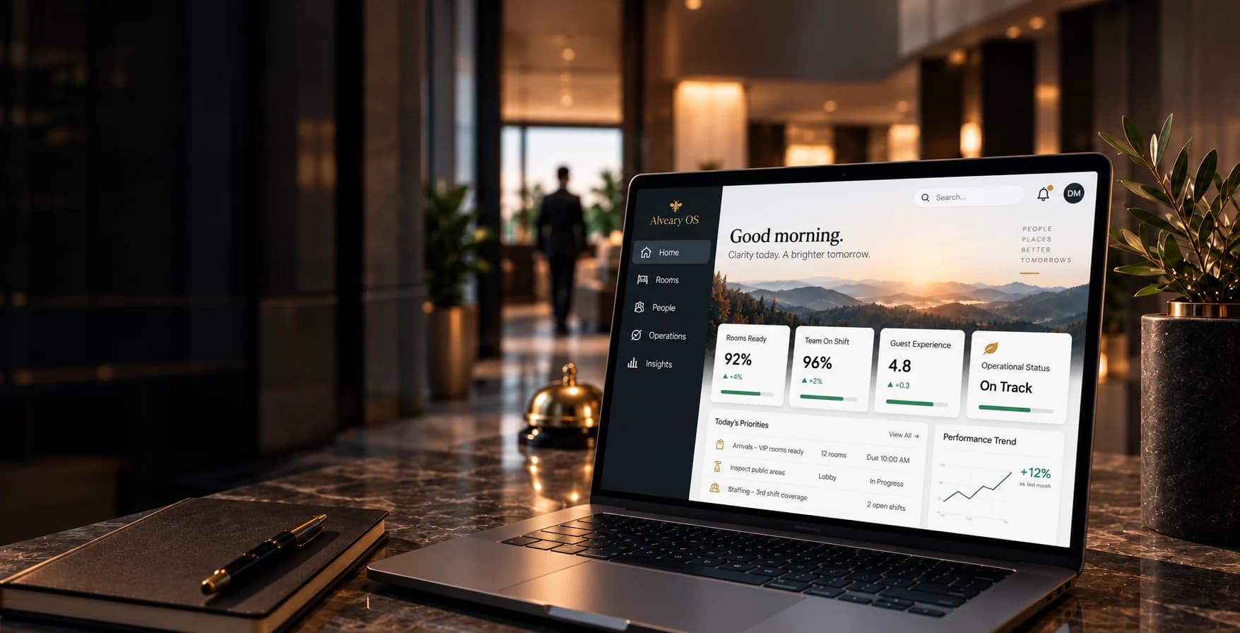 An illustrative Alveary OS dashboard on a laptop at a warmly lit hotel reception desk. All dashboard data is fictional.